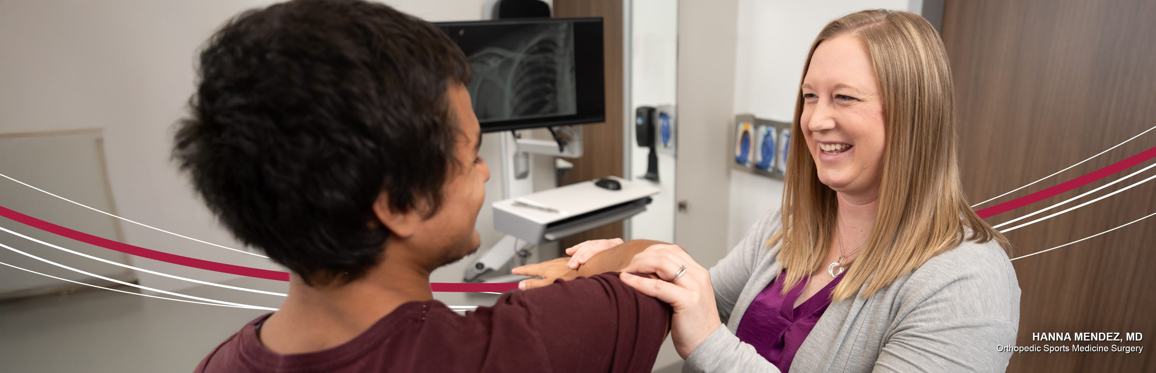 Image of a doctor smiling and helping their patient